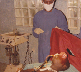 Doctors oprating on the girl's eye to remove the cancer